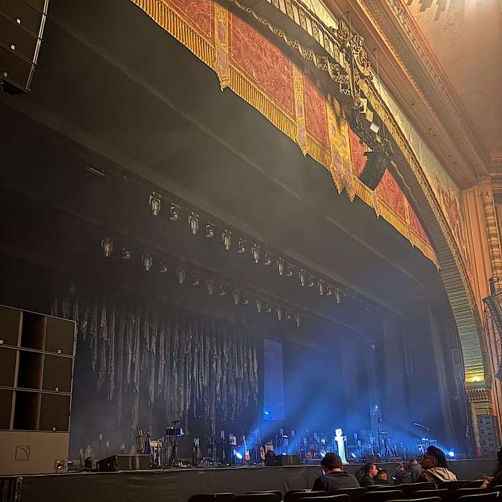 stage with fog and blue lights pointed toward the empty seats at The Shrine Auditorium at USC in Los Angeles