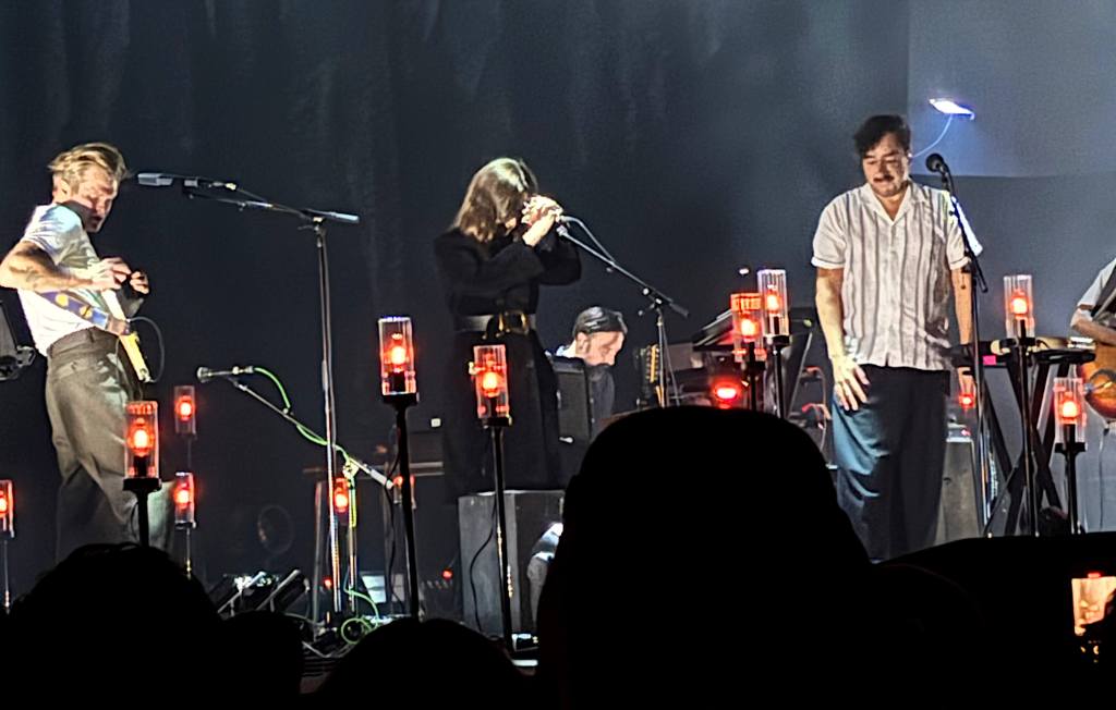 Grizzly Bear (far left: Chris Taylor; far right: Ed Droste) with Victoria Legrand (middle) onstage at the Shrine Auditorium in Los Angeles